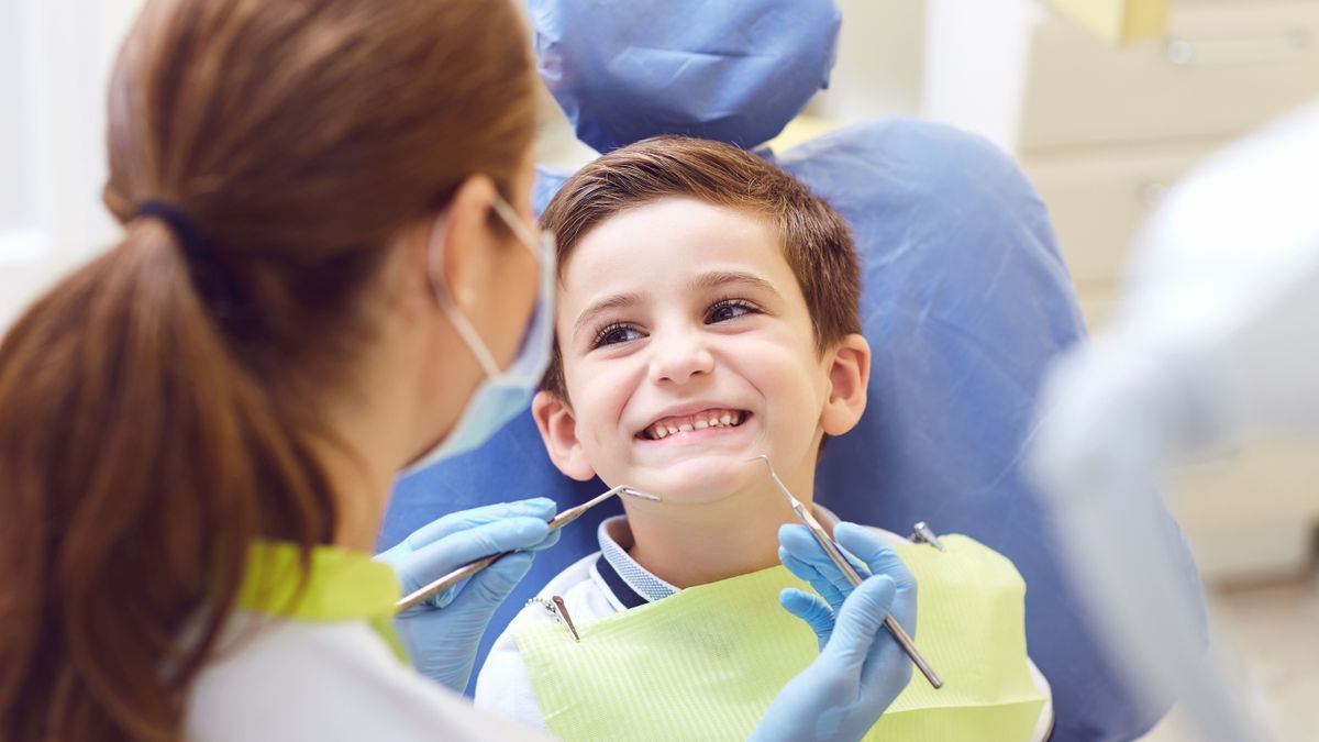 A,Child,With,A,Dentist,In,A,Dental,Office.
