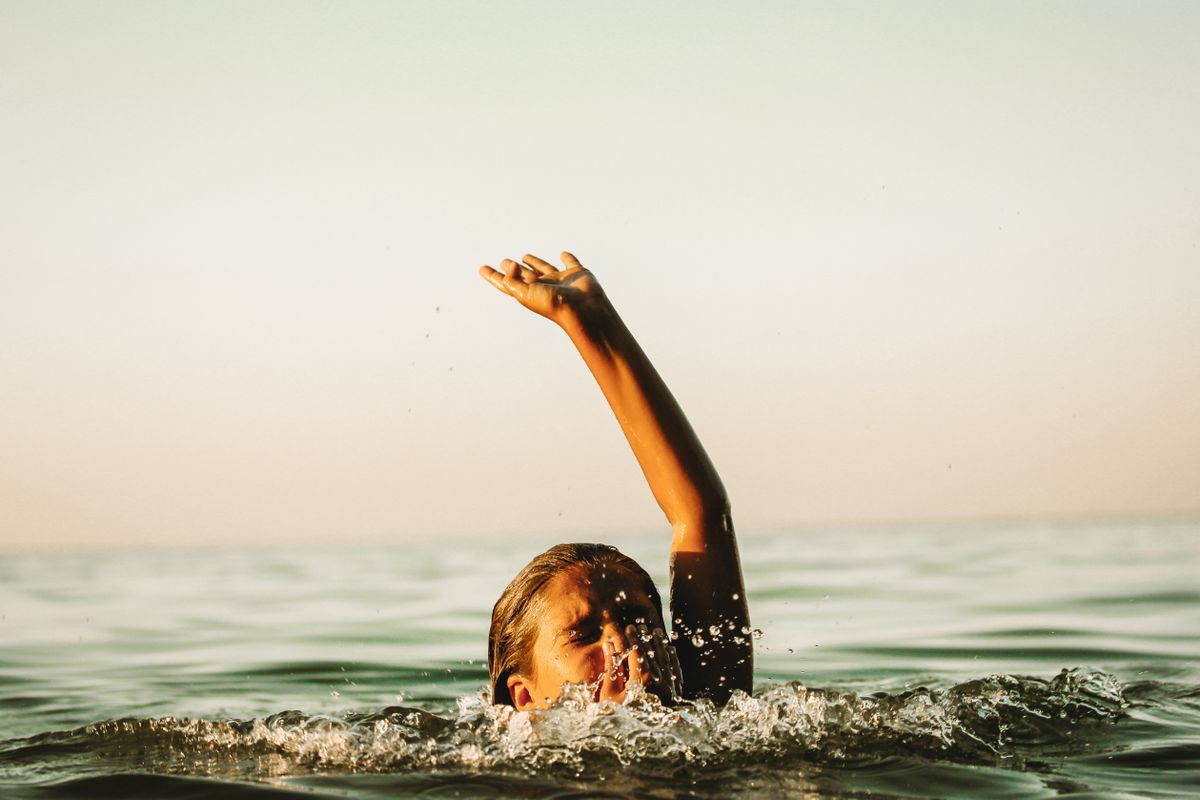 Child,Drowning,In,Water,Holding,Hand,Above,A,Surface,Of